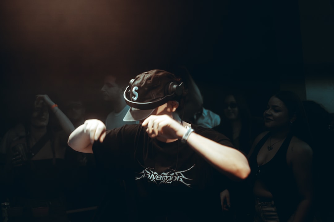 Man dancing in a dark club with friends