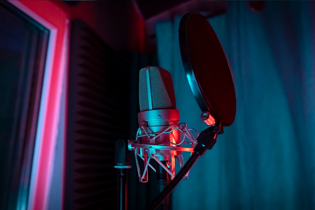 A microphone with a red light shining on it