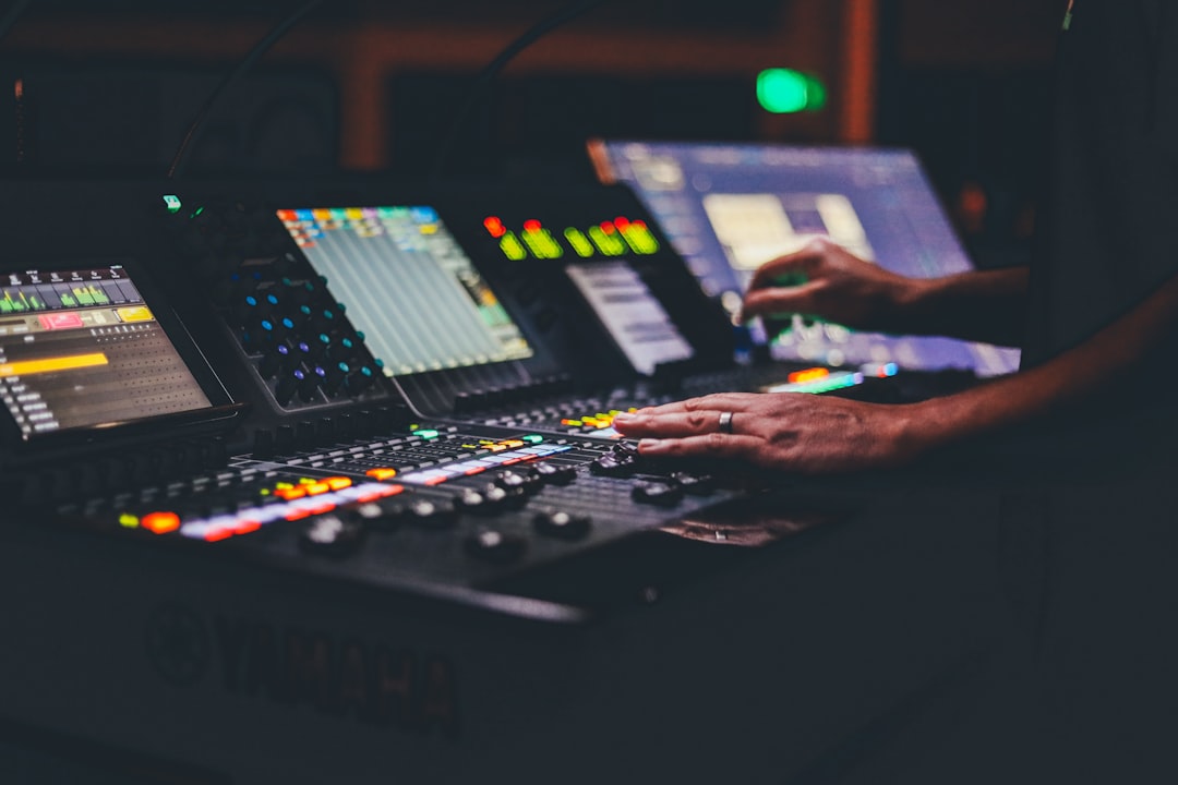 Person using black audio mixer