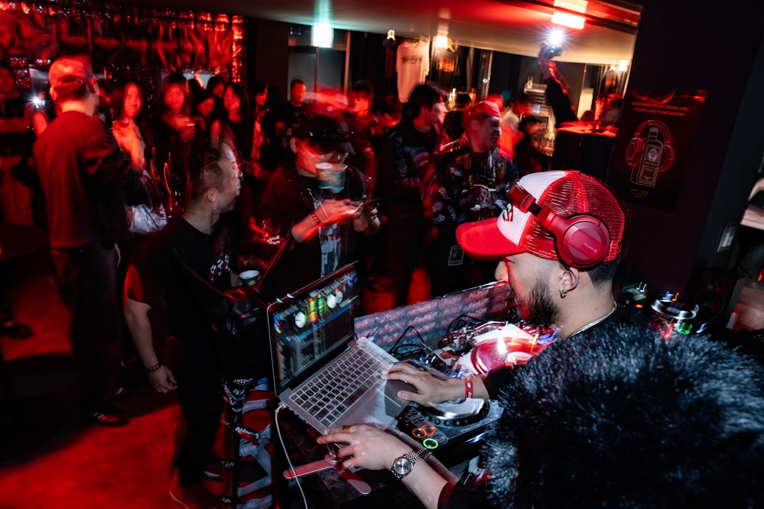 Dj playing music for a crowd at a party