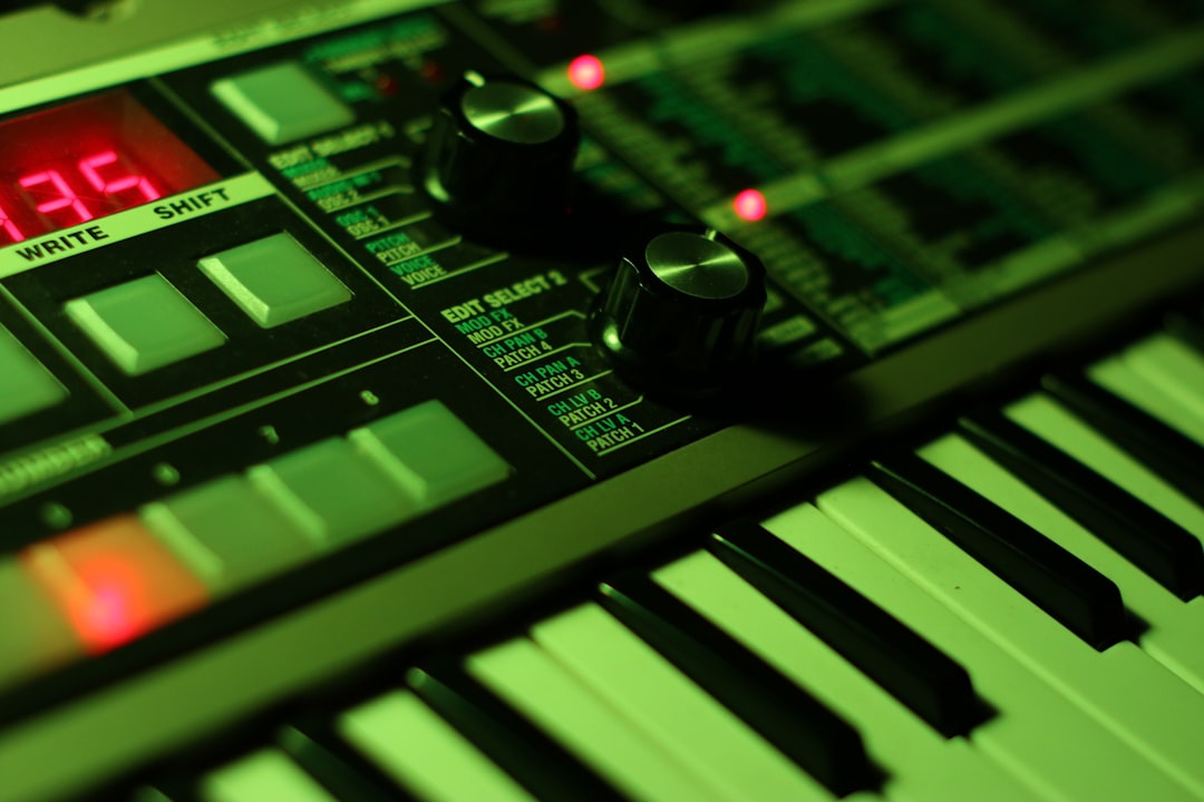 Close-up of a digital synthesizer with green lighting.