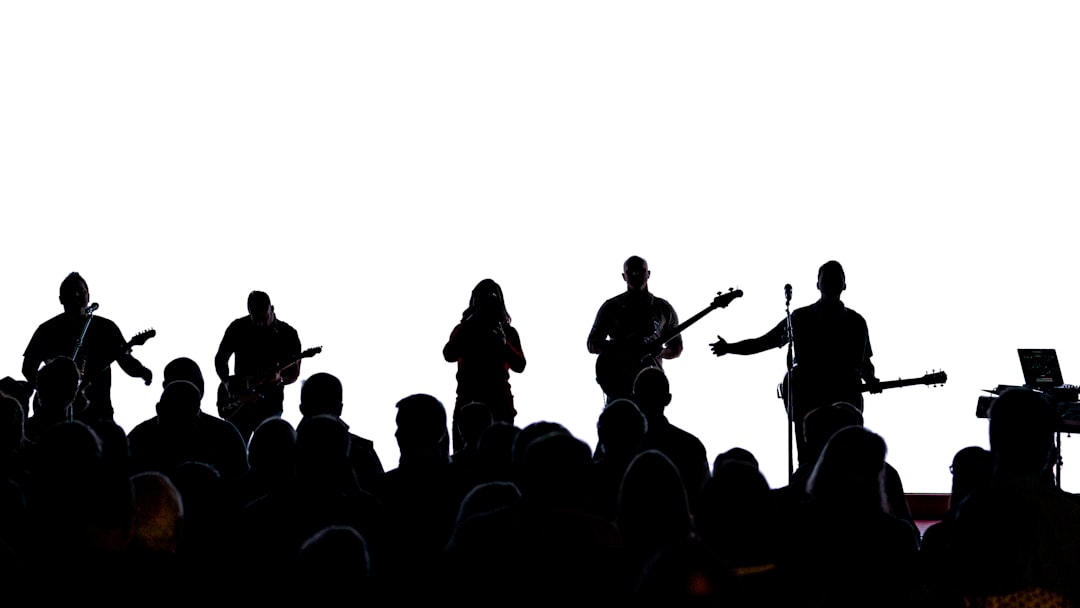 Silhouette of people standing on top of mountain