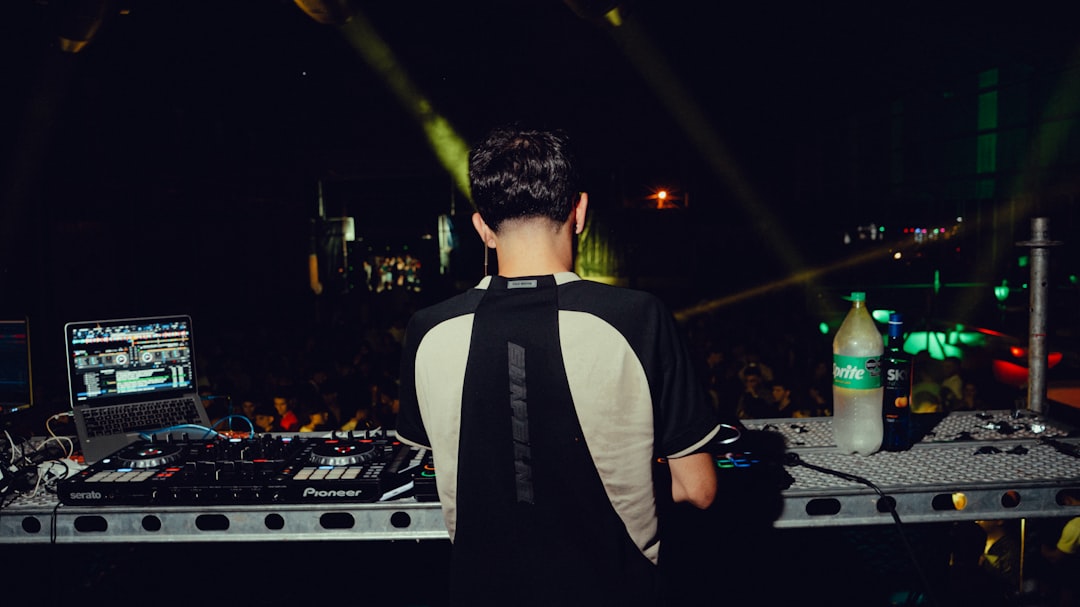 Dj performing at a concert with crowd in-ear monitors.