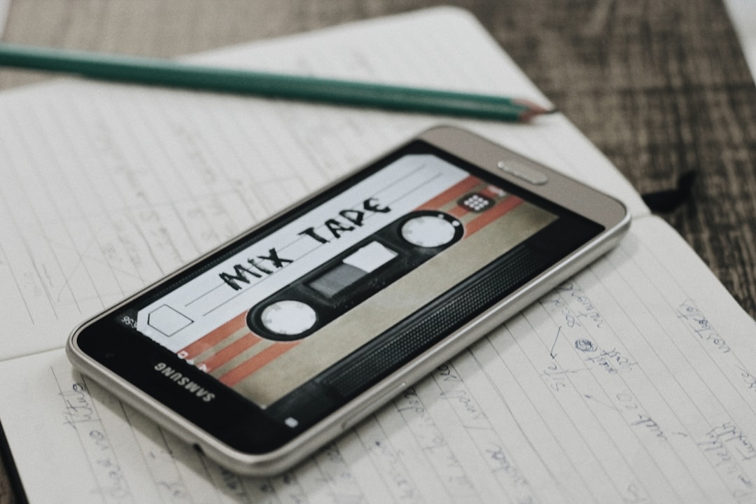 Silver and black Samsung smartphone on white paper