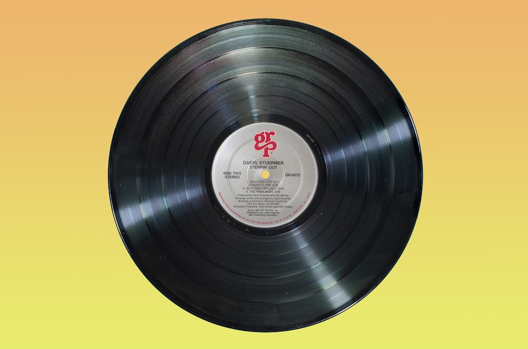 Black vinyl record on orange surface