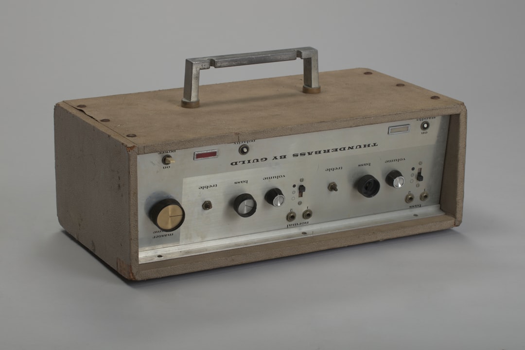 Vintage portable audio device with wooden casing and metal handle