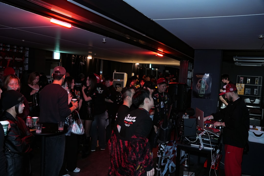 Dj playing music for a crowd at a bar