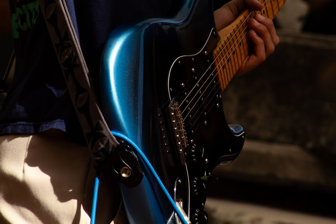 Someone is playing an electric guitar.