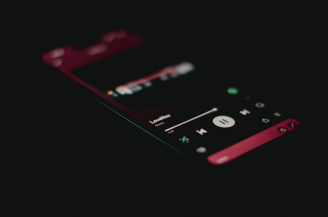 A close up of a cell phone on a black background