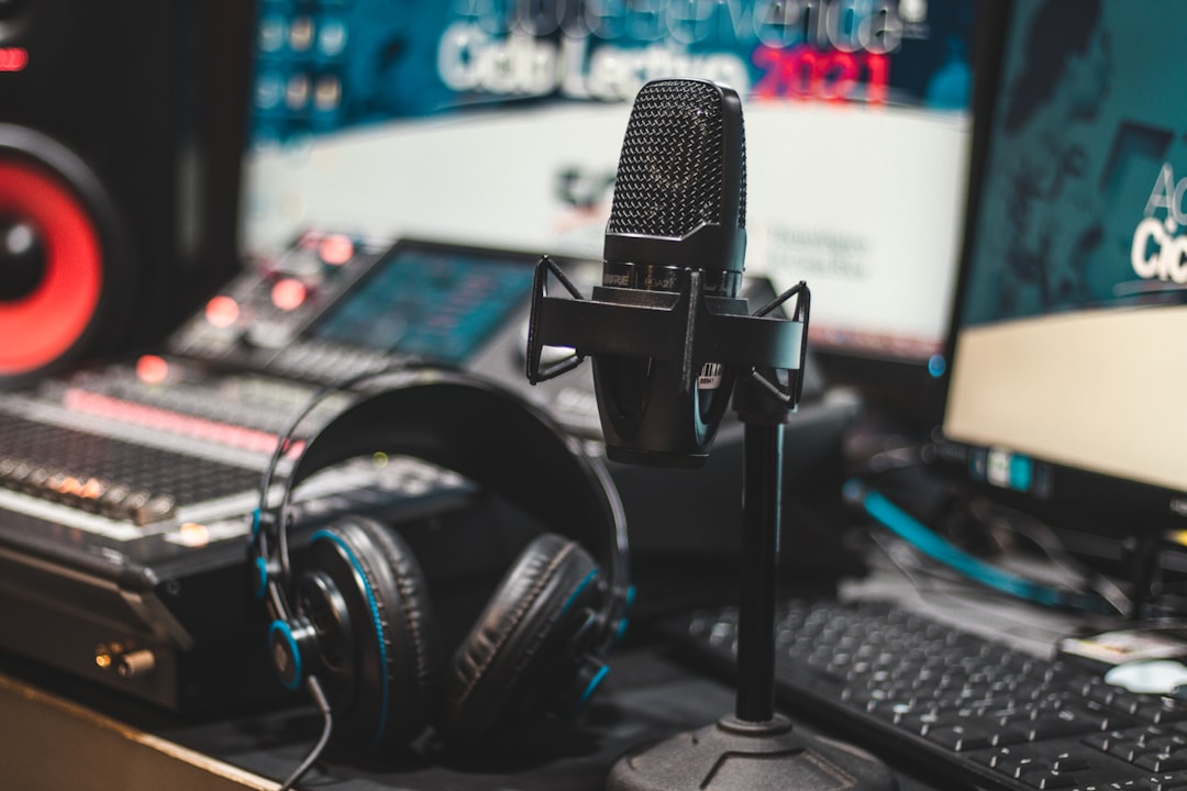Black and silver microphone on black computer keyboard