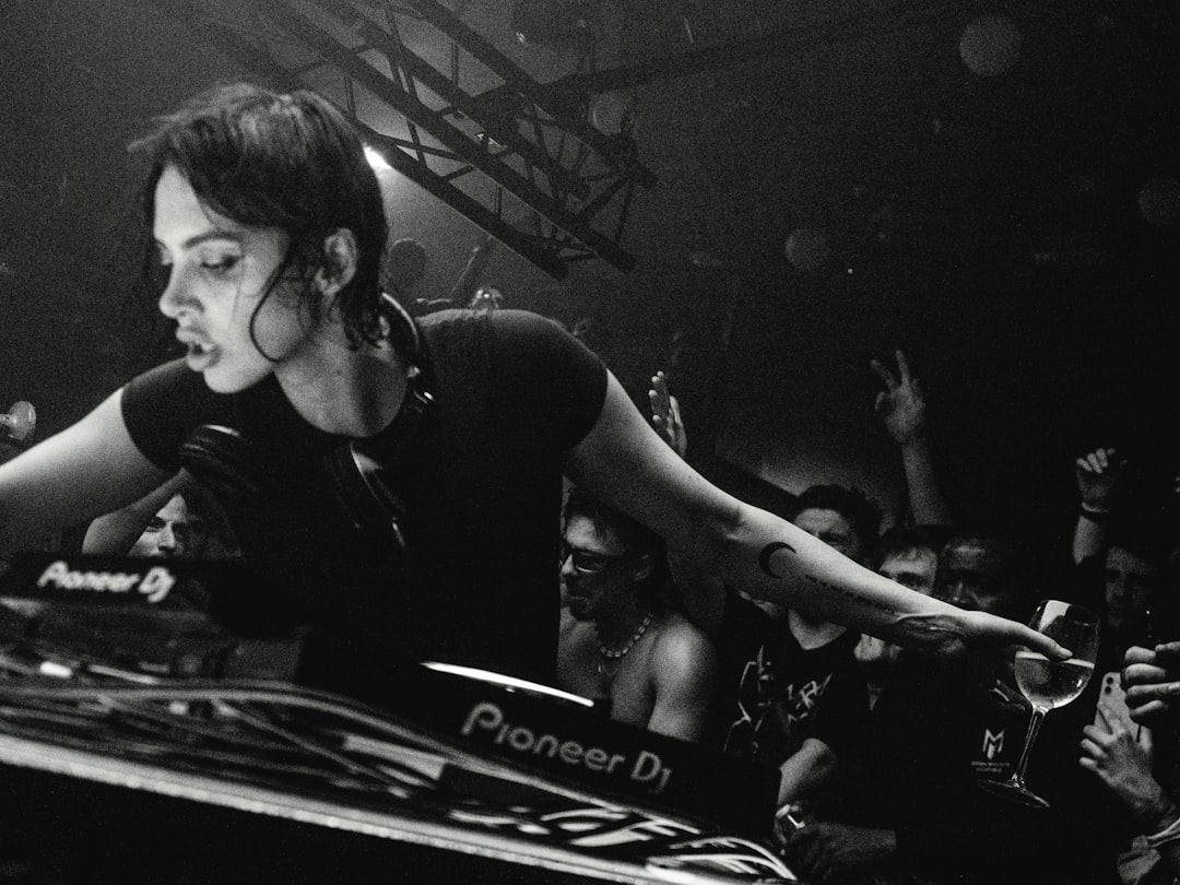 A female dj performing for a crowd at a concert