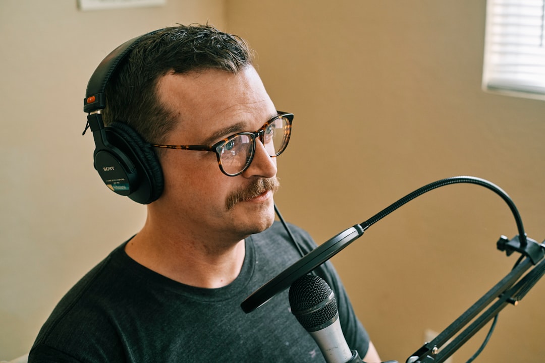 Man in black crew neck shirt wearing black headphones
