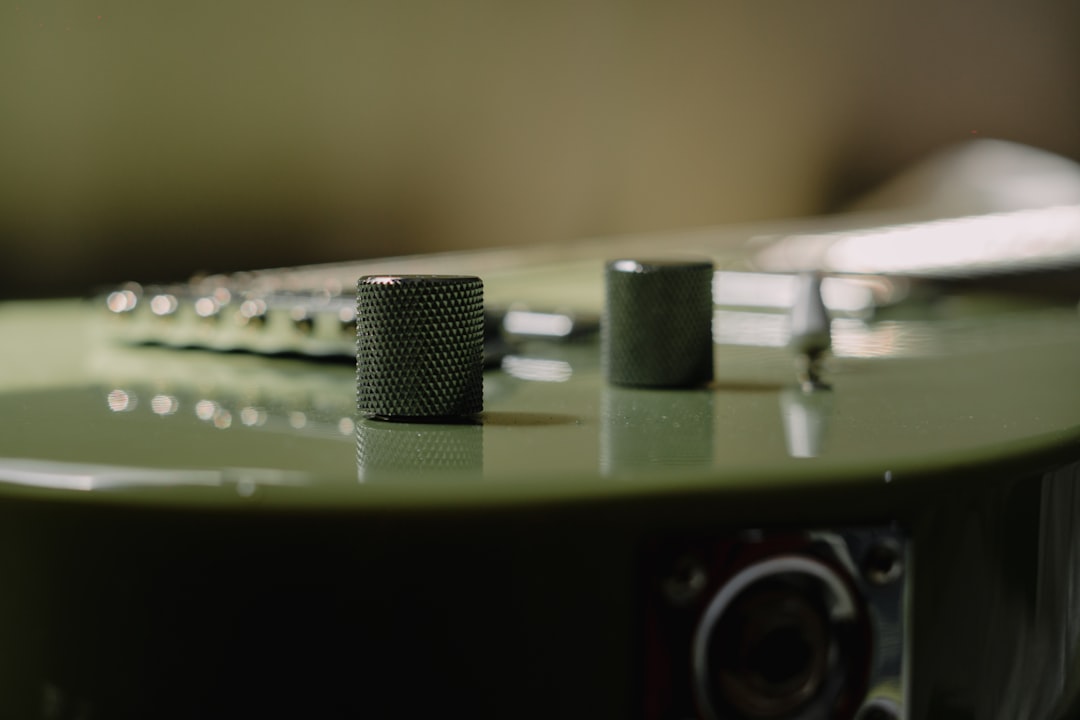 Electric guitar with control knobs and bridge.