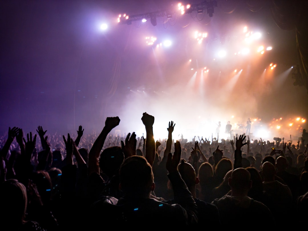 Crowd facing lighted stage