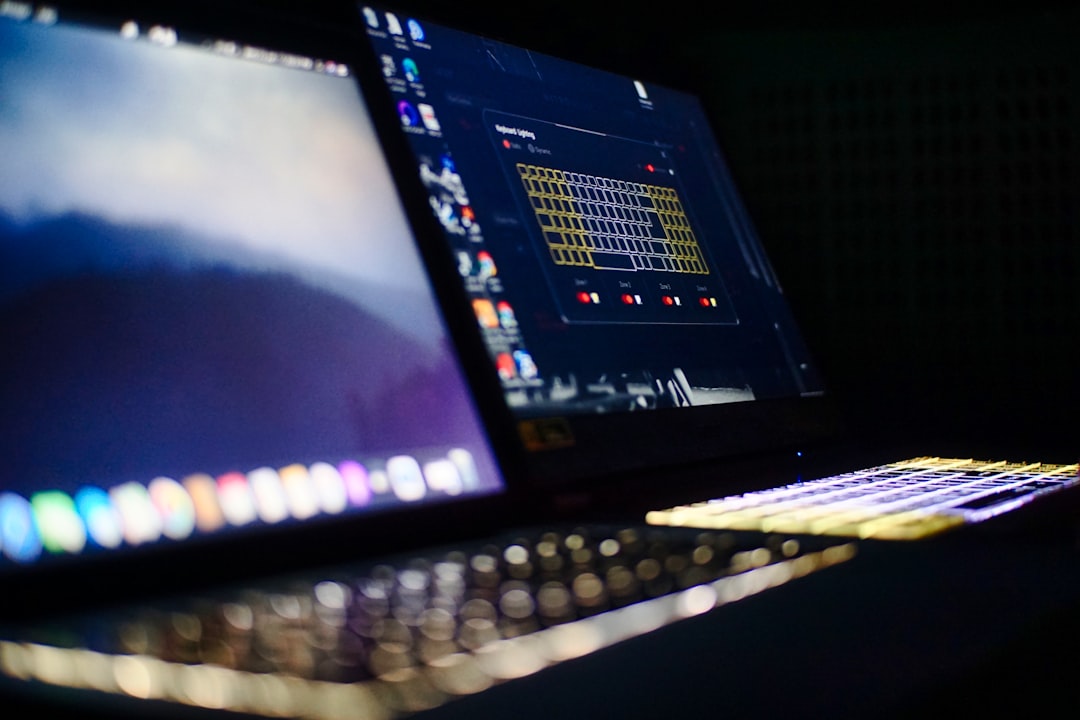 Black laptop computer turned on displaying music player