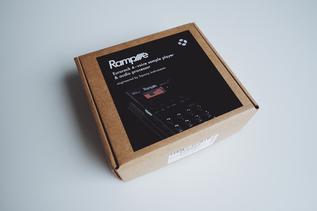 Cardboard box with black lid and electronic device
