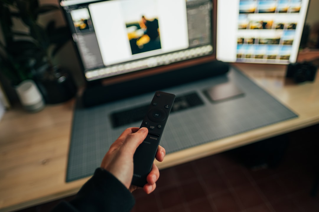 Person holding black remote control