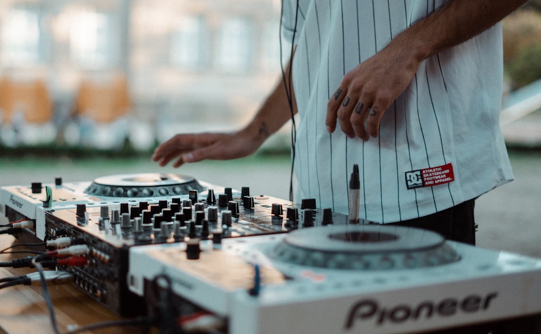 Man playing Pioneer DJ controller