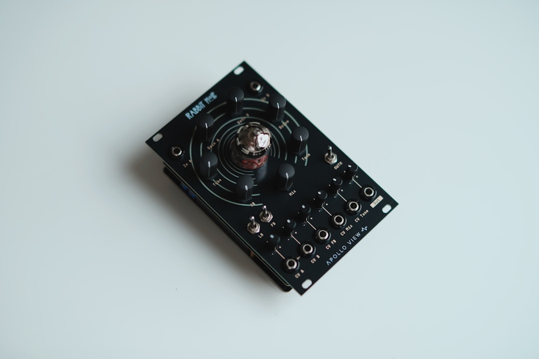 Black electronic device with a central glass tube.