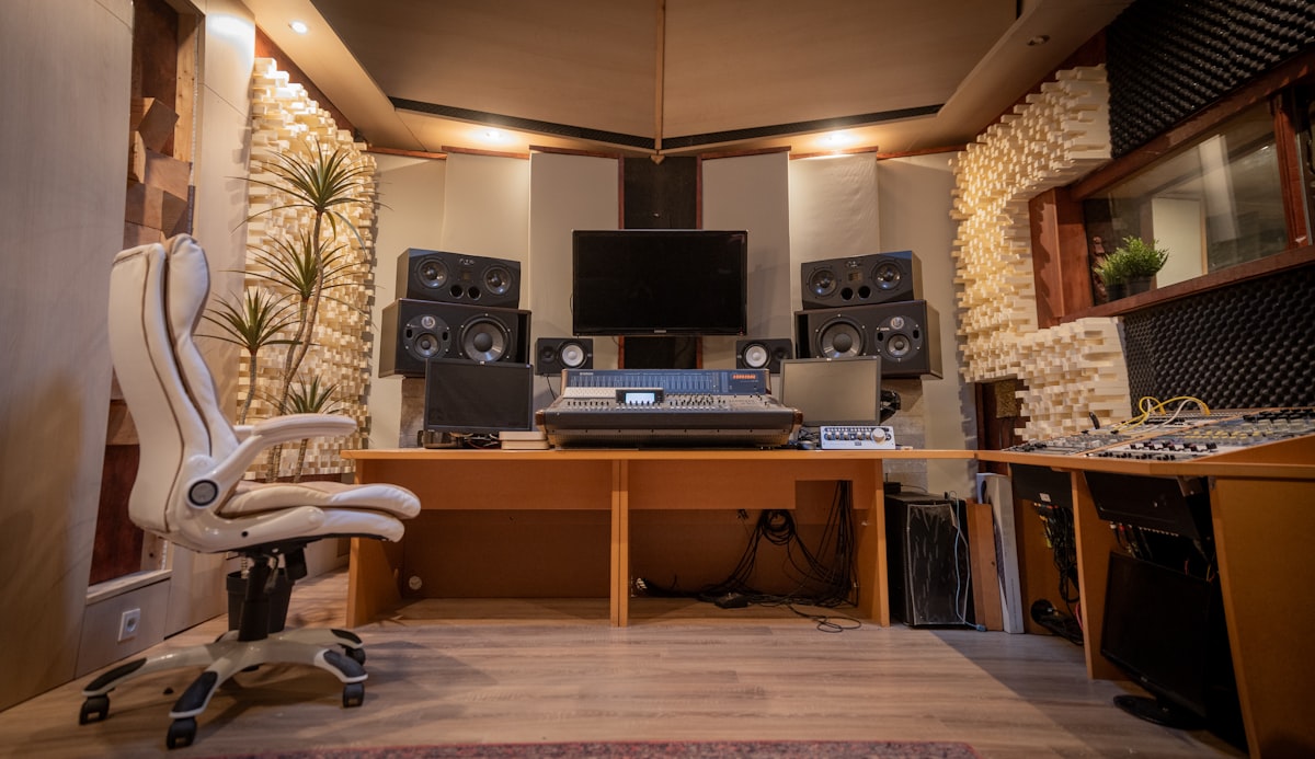 Professional recording studio control room with studio monitors, a mixing console and acoustic foam treatment