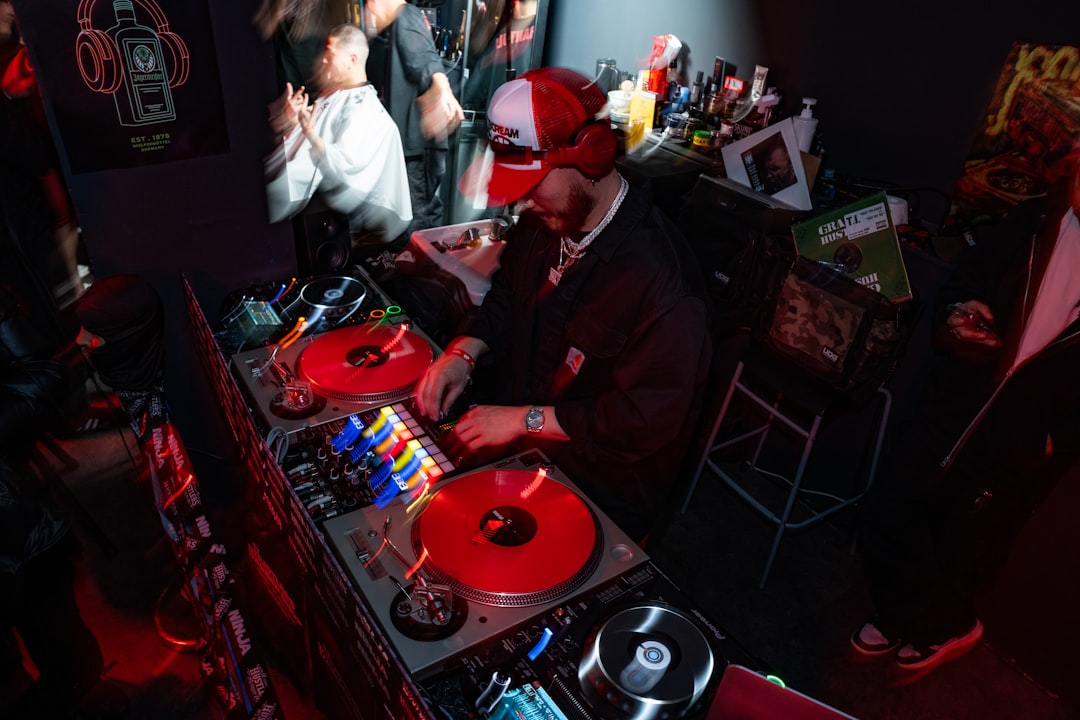 Dj spinning records at a club with people dancing