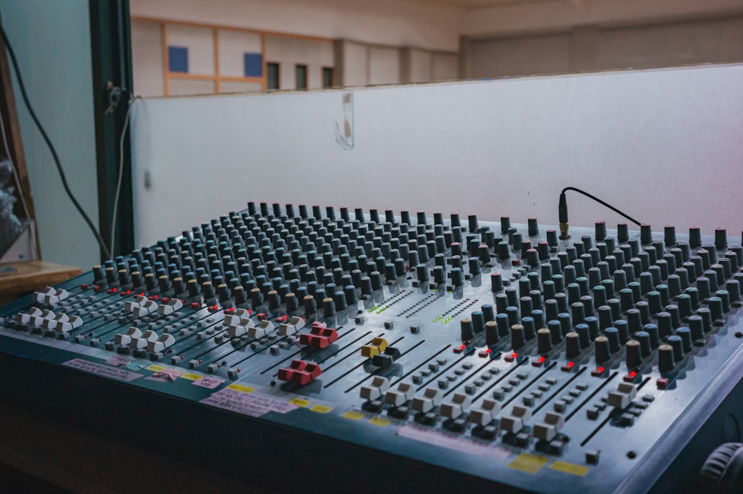 A large audio mixing board with many knobs.