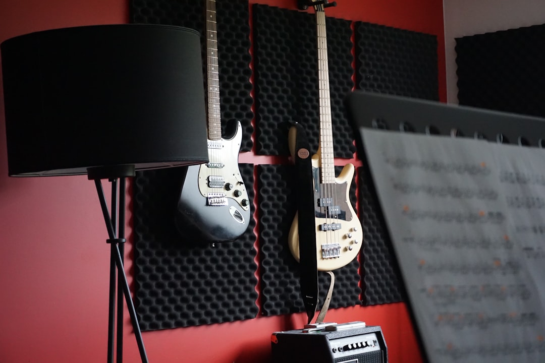 A couple of guitars are hanging on a wall